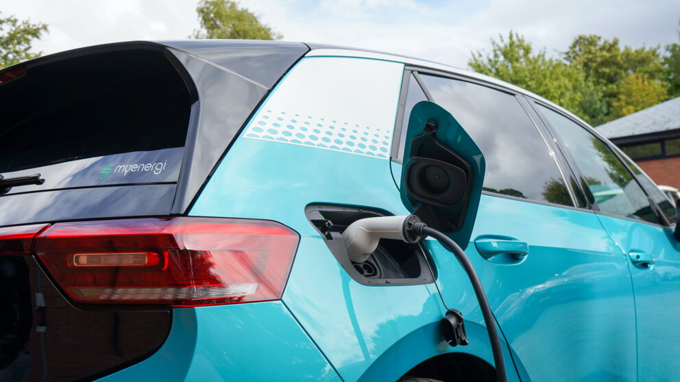 Close-up of an electric car connected to a charging station.