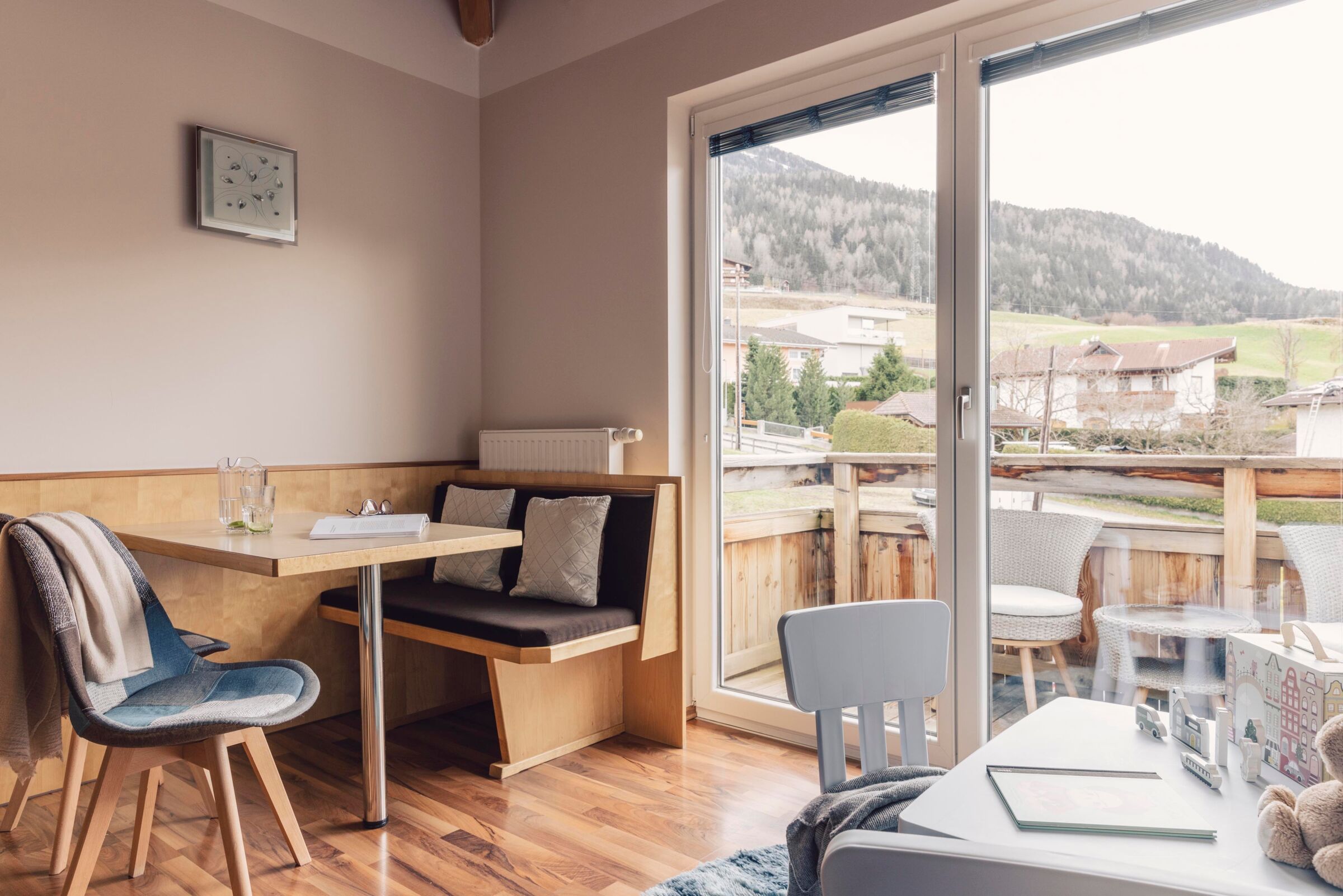 Sun-drenched seating area with a view of the Tyrolean mountains, perfect for family time.