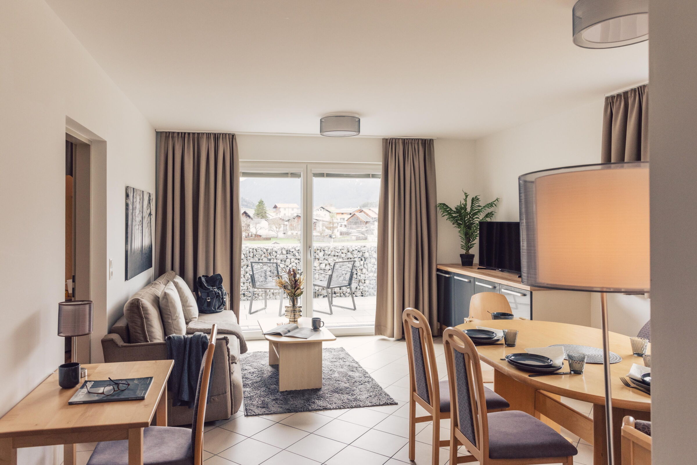 Cozy living room with balcony and view of the Tyrolean Alps.