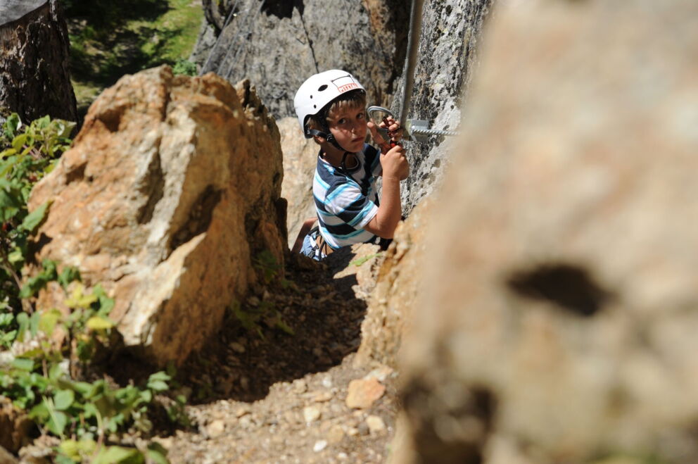 A child climbing in the climbing park in Pitztal.
